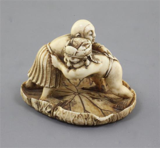 A Japanese ivory netsuke of two wrestlers, Meiji period, w. 4.2cm